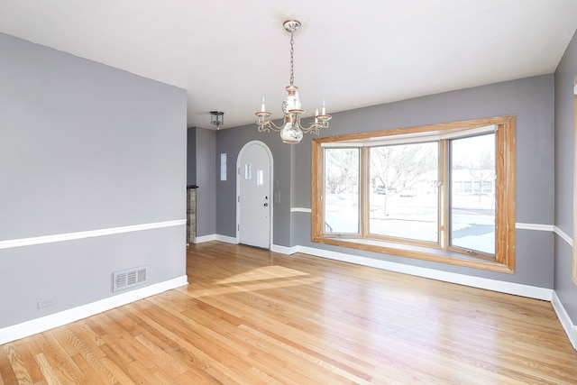 interior space with hardwood / wood-style flooring and a notable chandelier