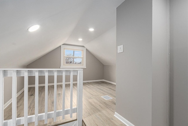 bonus room with vaulted ceiling and hardwood / wood-style floors