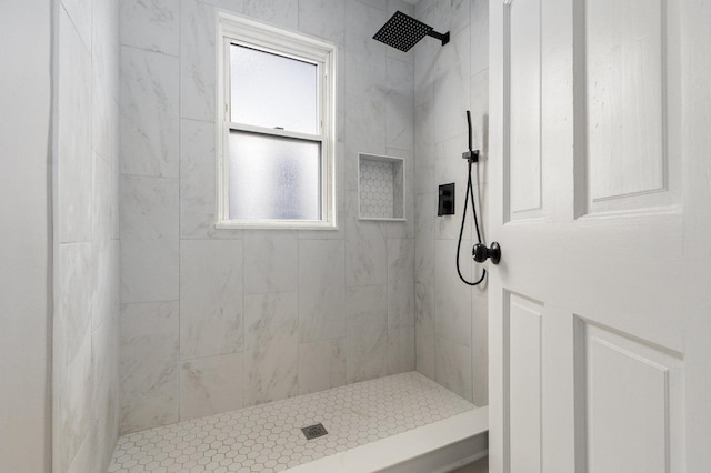 bathroom featuring tiled shower