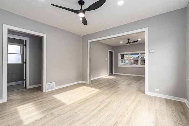 empty room featuring ceiling fan and light wood-type flooring