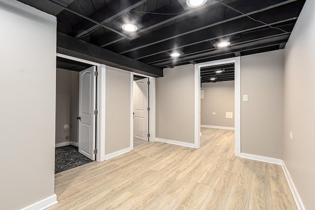 basement with light hardwood / wood-style floors