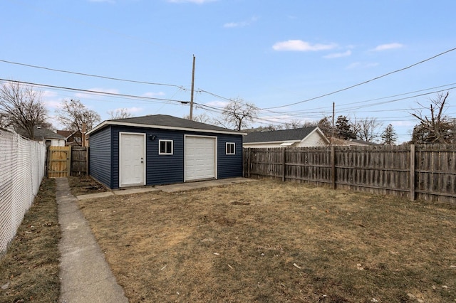 view of outbuilding with a garage and a lawn