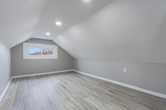 bonus room with lofted ceiling and light hardwood / wood-style floors