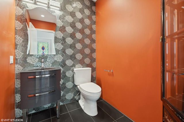 bathroom featuring toilet, wallpapered walls, vanity, and tile patterned floors