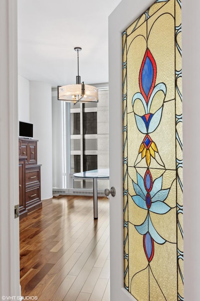 interior space with an inviting chandelier and wood finished floors