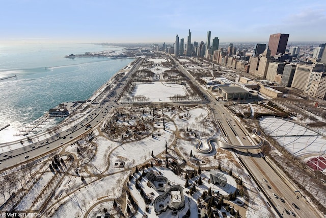 birds eye view of property with a water view and a city view