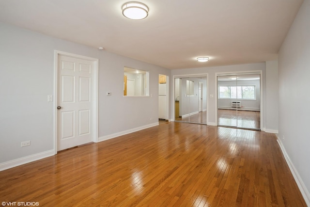 unfurnished room featuring hardwood / wood-style flooring