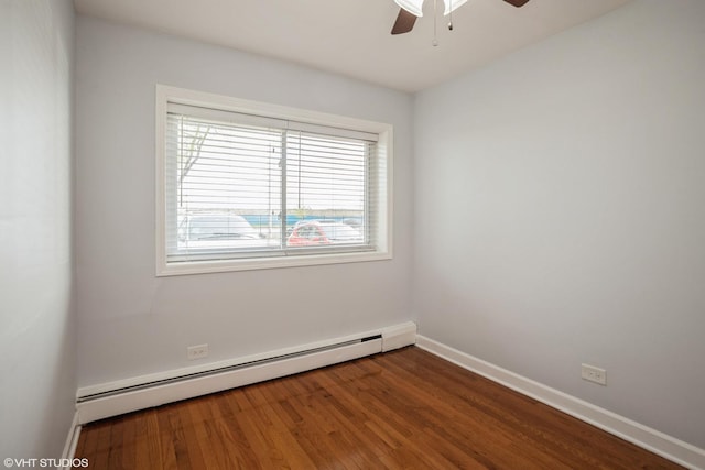 spare room with hardwood / wood-style flooring, ceiling fan, and baseboard heating