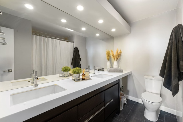 full bath featuring double vanity, recessed lighting, toilet, a sink, and tile patterned floors