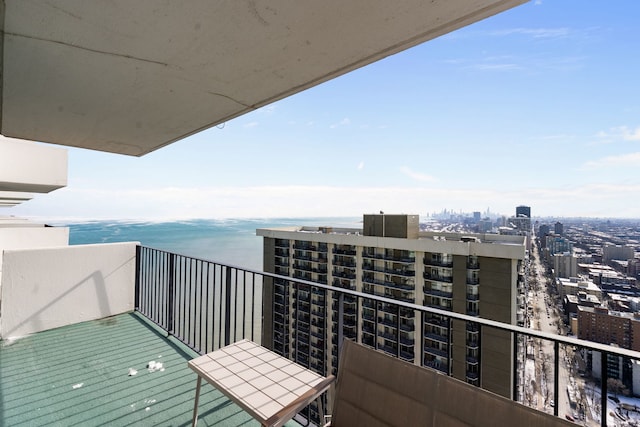 balcony with a water view and a city view