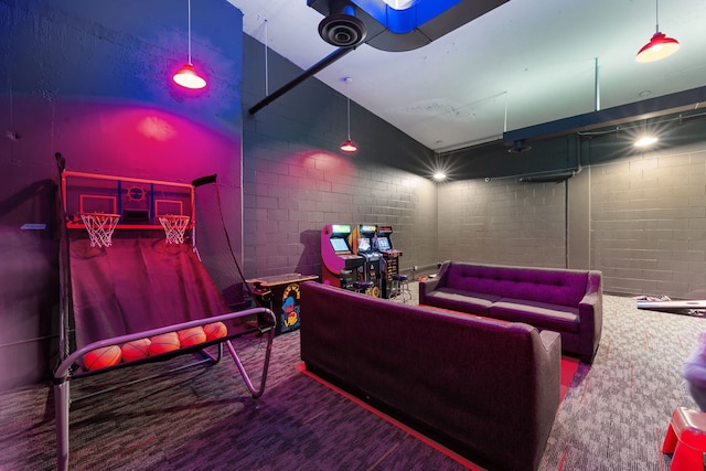 home theater room featuring lofted ceiling and brick wall