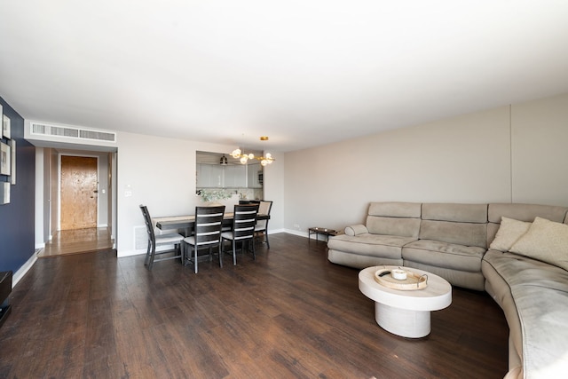 living room with baseboards, visible vents, a chandelier, and dark wood-style flooring