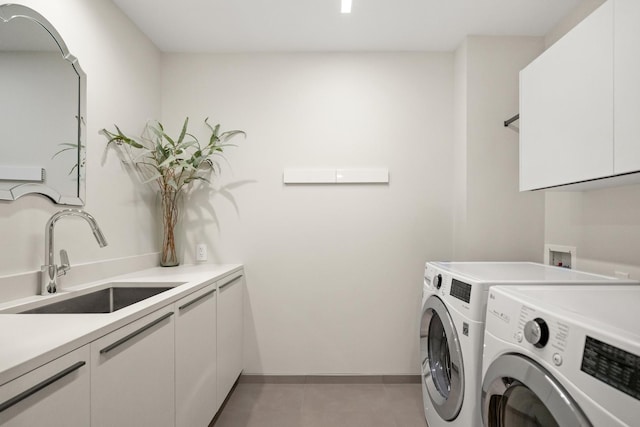 laundry room featuring sink, cabinets, independent washer and dryer, and light tile patterned flooring