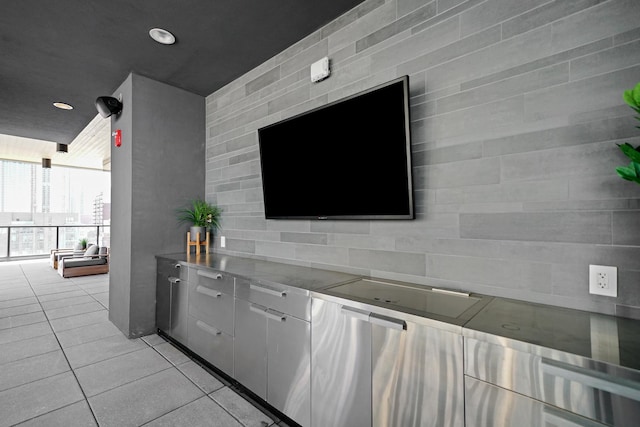 kitchen featuring white cabinetry, expansive windows, stainless steel counters, and light tile patterned floors