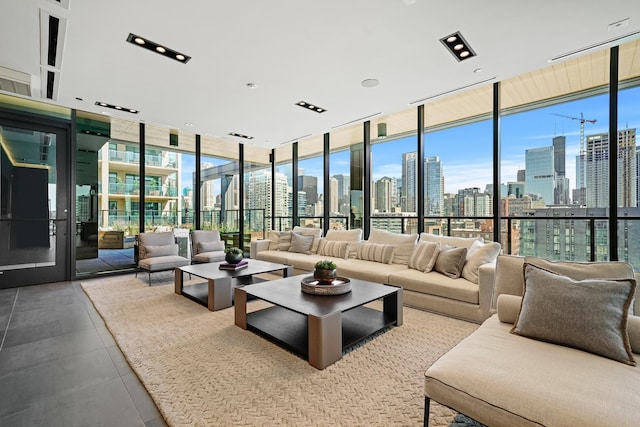 living room with expansive windows, plenty of natural light, and tile patterned floors