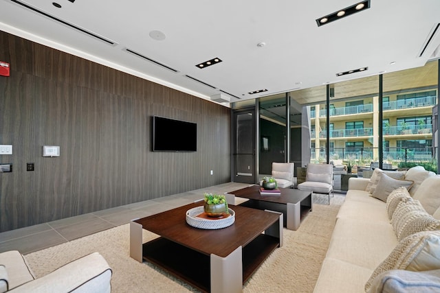 living room with light tile patterned floors and expansive windows