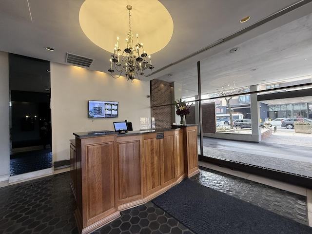 welcome area with a chandelier and visible vents