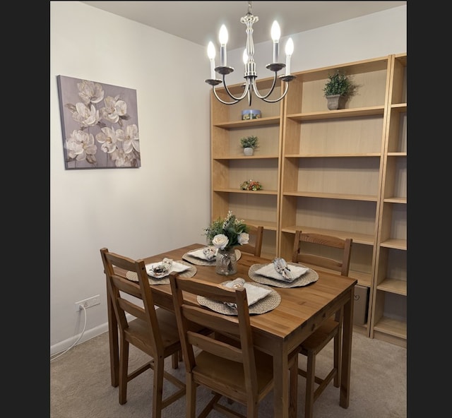 dining area with light carpet, baseboards, and a notable chandelier