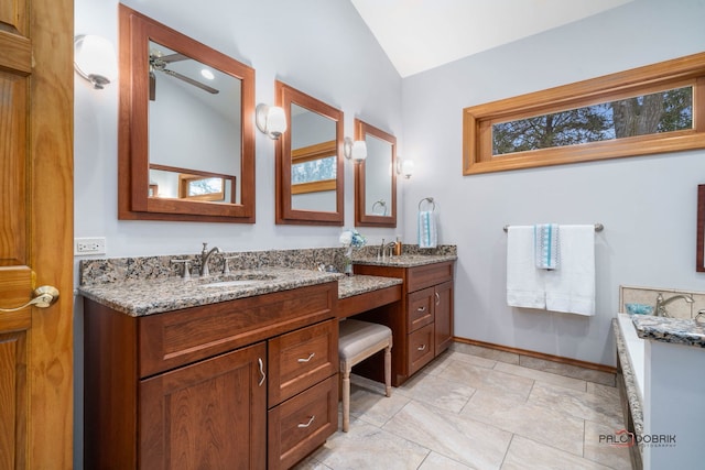 bathroom featuring vaulted ceiling, vanity, and ceiling fan