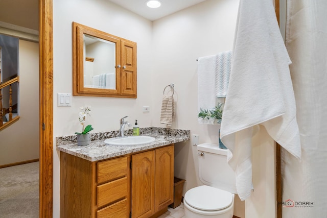 bathroom featuring vanity and toilet