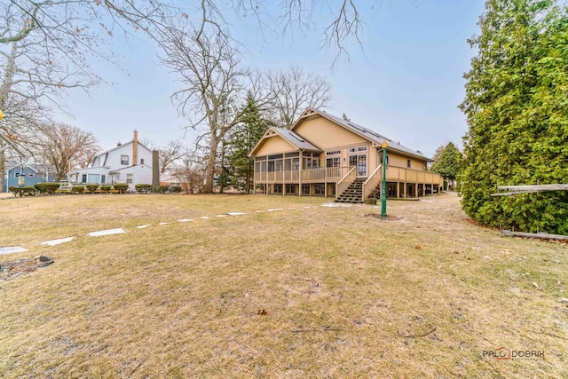 view of yard featuring a deck and a sunroom