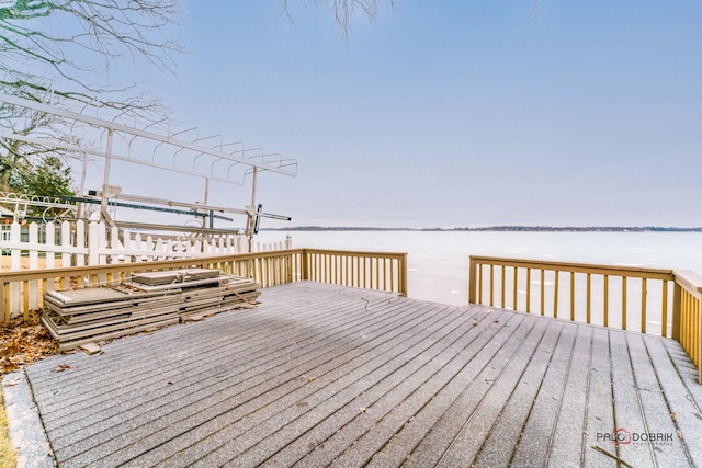 wooden terrace featuring a water view