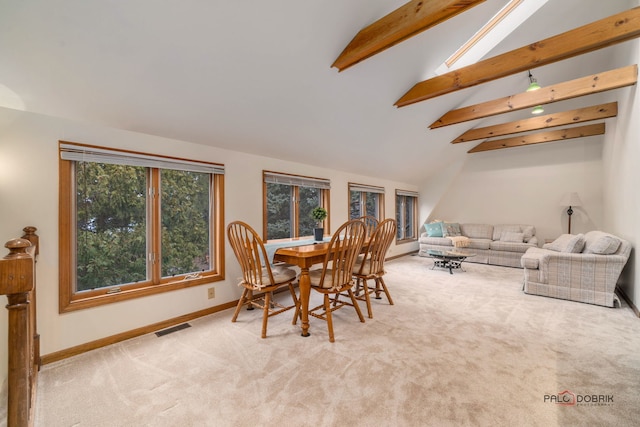 dining space featuring beamed ceiling, high vaulted ceiling, and light carpet