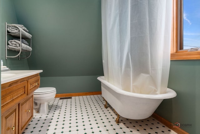 bathroom featuring vanity, a bathing tub, and toilet