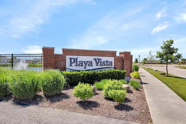 community sign featuring a water view