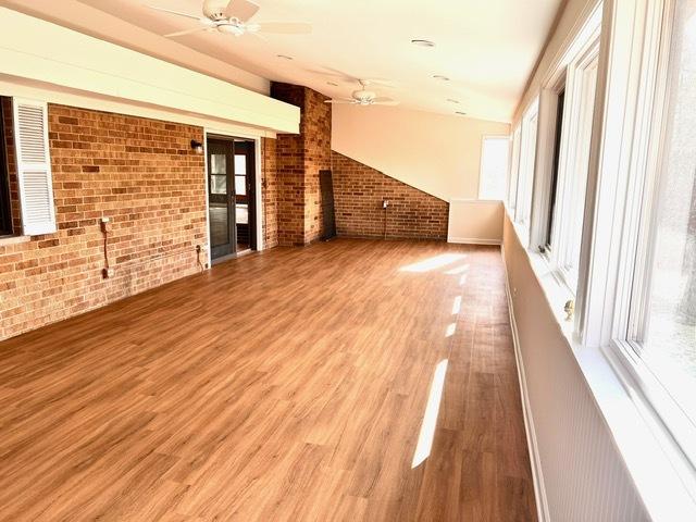 interior space with hardwood / wood-style flooring, ceiling fan, and plenty of natural light