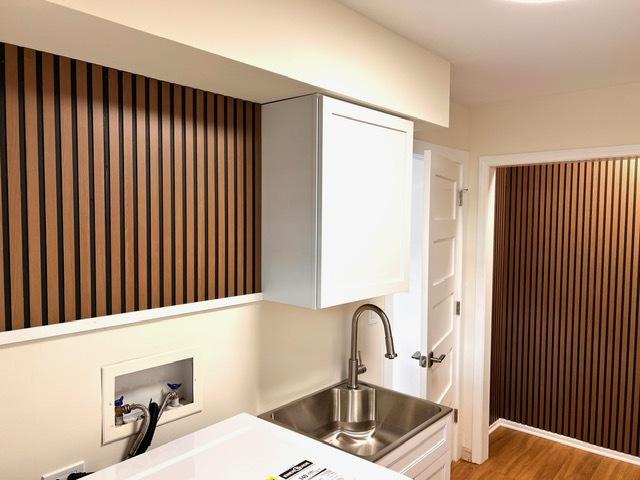 kitchen featuring sink, white cabinets, and light hardwood / wood-style floors