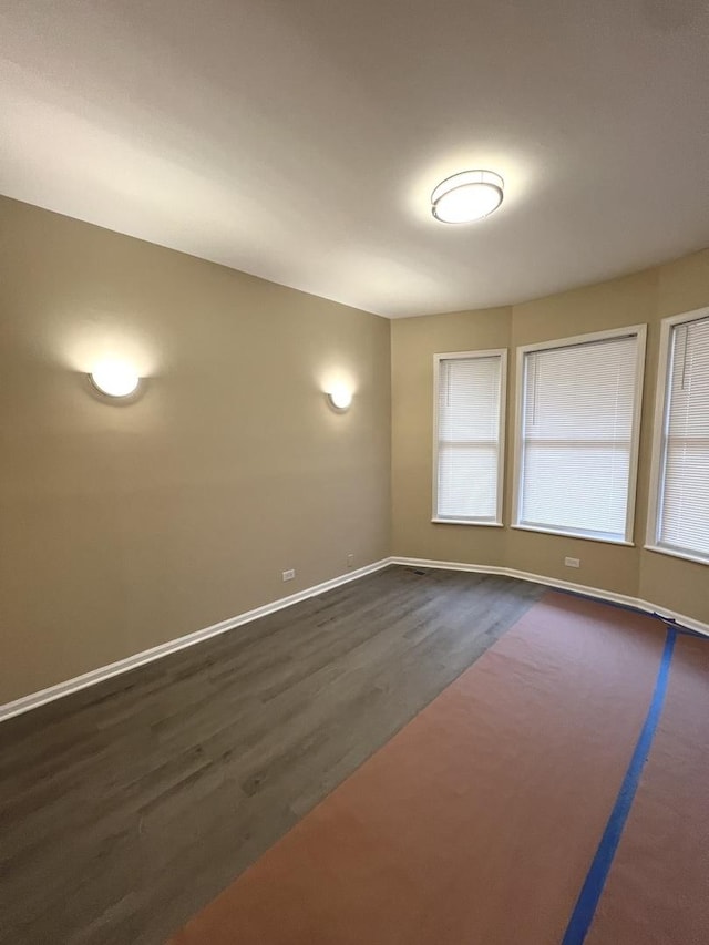 spare room with dark hardwood / wood-style floors