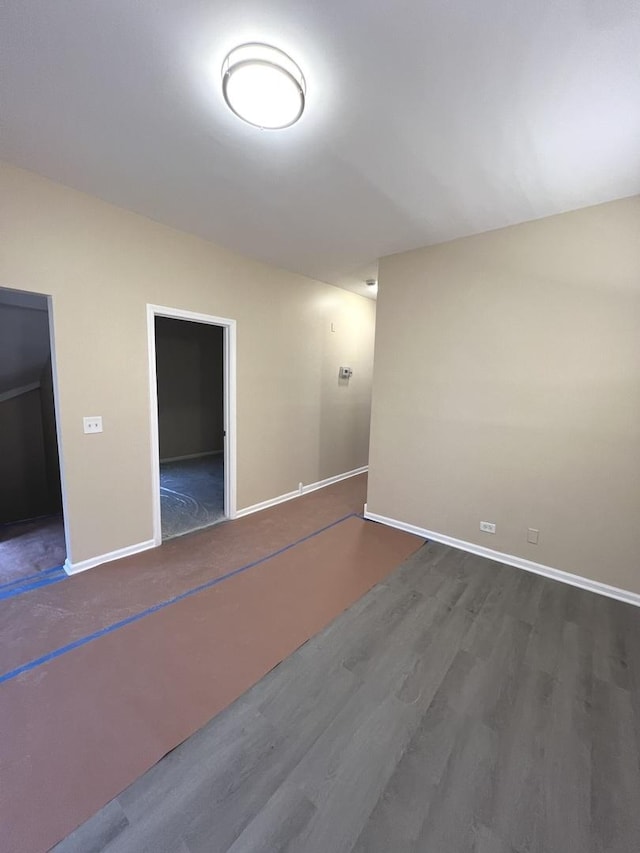 empty room with dark hardwood / wood-style floors