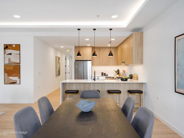 dining space featuring sink and light wood-type flooring