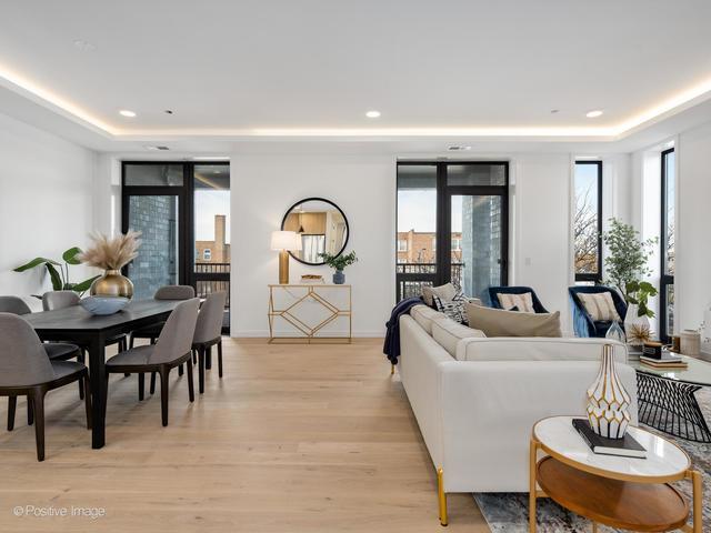 living room featuring a tray ceiling and light wood-type flooring