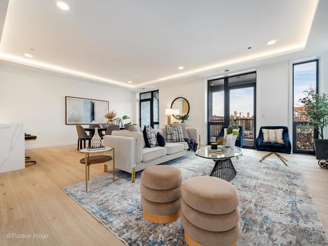 living room with a raised ceiling and light hardwood / wood-style floors