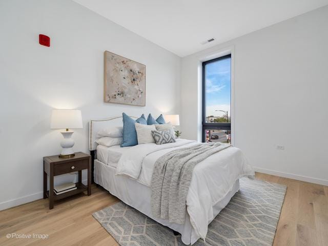 bedroom with hardwood / wood-style floors