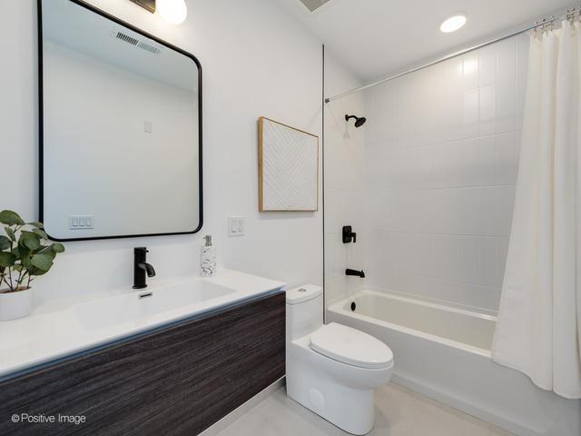 full bathroom with vanity, shower / bath combination with curtain, and toilet