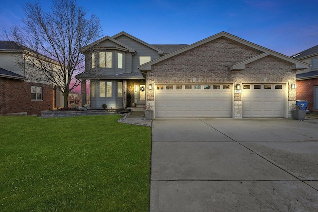 view of front of house with a garage and a lawn