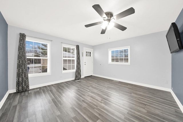 unfurnished living room with ceiling fan and dark hardwood / wood-style flooring