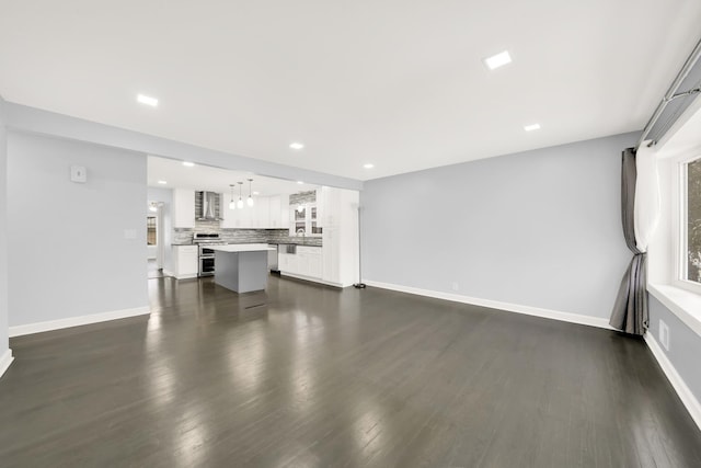 unfurnished living room with dark hardwood / wood-style floors