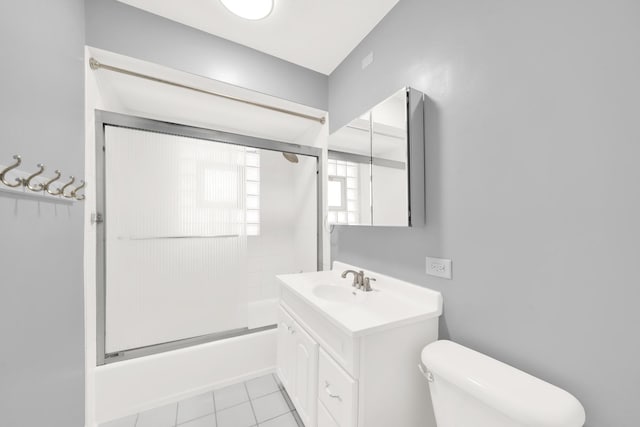 full bathroom with tile patterned flooring, vanity, shower / bath combination with glass door, and toilet