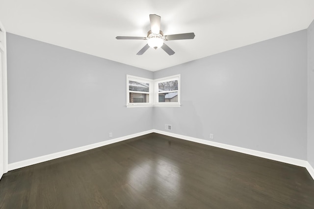 unfurnished room with dark hardwood / wood-style floors and ceiling fan