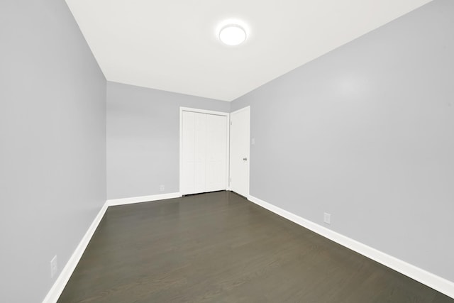 empty room featuring dark hardwood / wood-style flooring