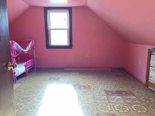 additional living space featuring vaulted ceiling