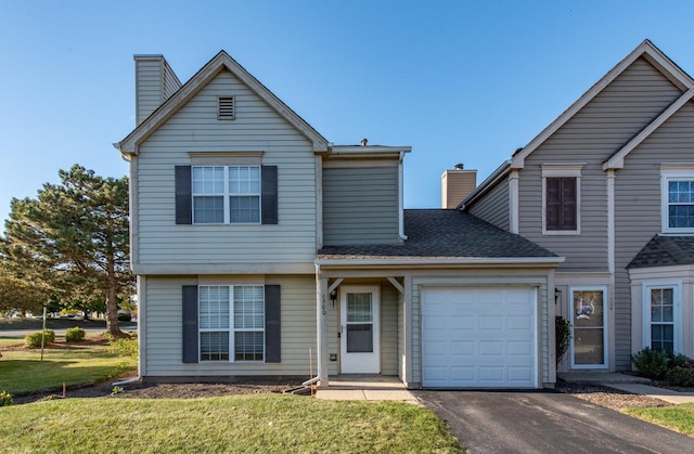 front of property with a garage and a front lawn