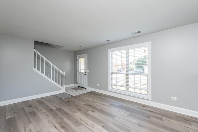 unfurnished room with light wood-type flooring