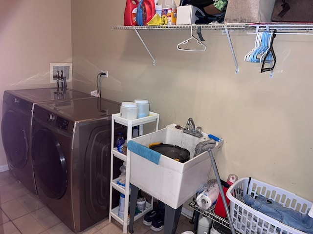 laundry area featuring washing machine and dryer and light tile patterned flooring