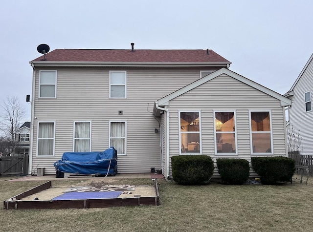 rear view of house featuring a yard