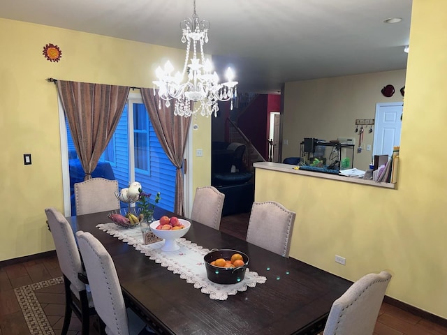 dining area with an inviting chandelier and dark hardwood / wood-style floors